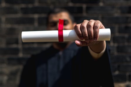 student-outside-holding-out-diploma_4460x4460